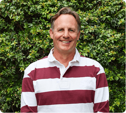 Professional portrait of Willem van der Merwe outdoors.